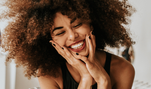 Woman with natural curly hair smiling